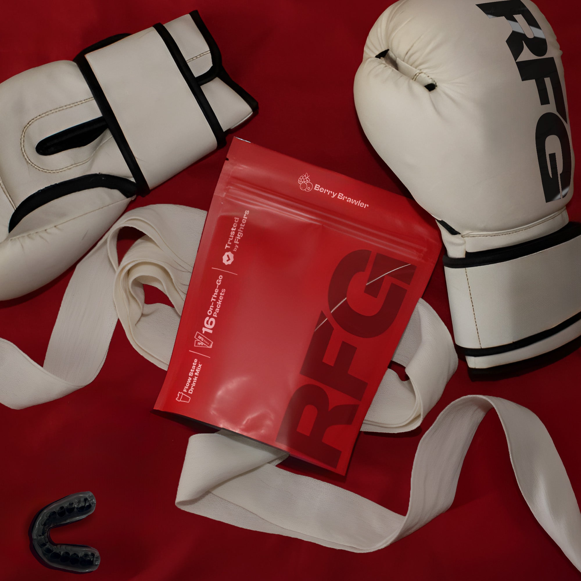 RFG pouch laying slightly tilted on a red background next to RFG gloves, mouth guard and wrapping tape.